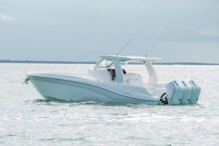 The Image of 2025 Deep Impact 369 Sport boat on calm water, featuring triple outboard engines. - 0