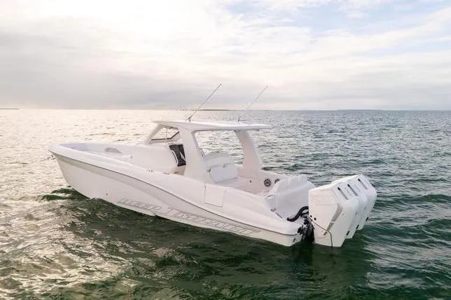 Slide: The Image of 2025 Deep Impact 369 Sport boat on calm ocean waters under a cloudy sky. - 10