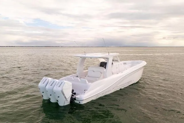 Slide: The Image of 2025 Deep Impact 369 Sport boat with triple engines on calm water. - 12