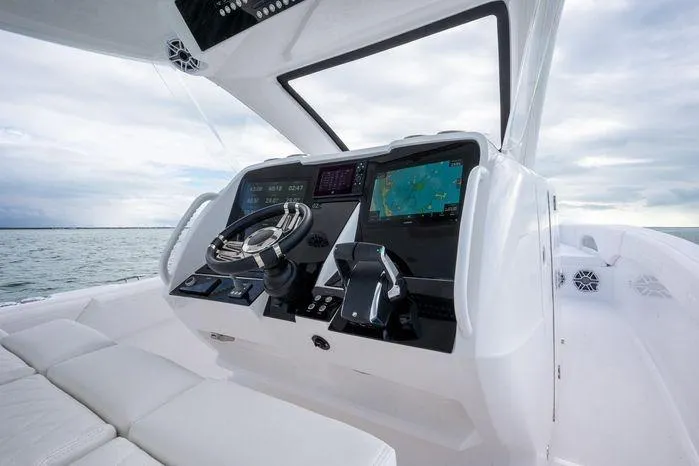 Slide: The Image of 2025 Deep Impact 369 Sport boat cockpit with advanced navigation system and steering wheel. - 6