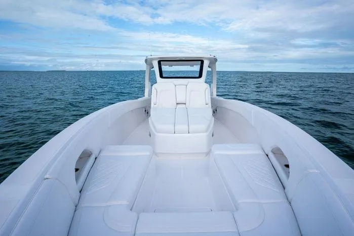 Slide: The Image of 2025 Deep Impact 369 Sport boat on open water, featuring sleek white seating and modern design. - 9
