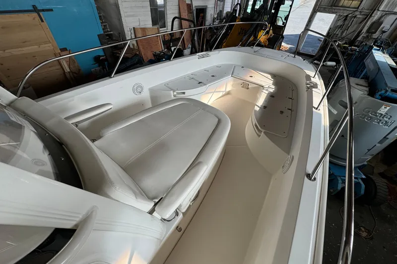 Slide: The Image of 2014 Boston Whaler 270 Dauntless boat interior with seating and storage compartments. - 10