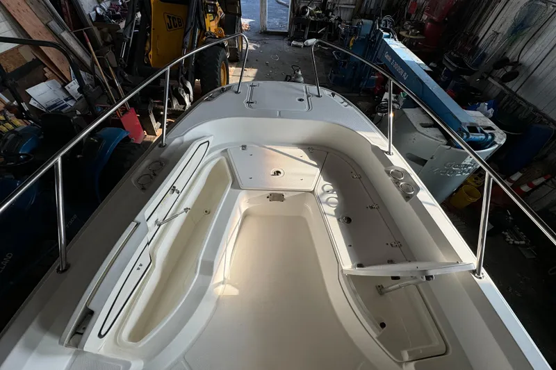 Slide: The Image of 2014 Boston Whaler 270 Dauntless boat interior, featuring spacious seating and storage compartments. - 12