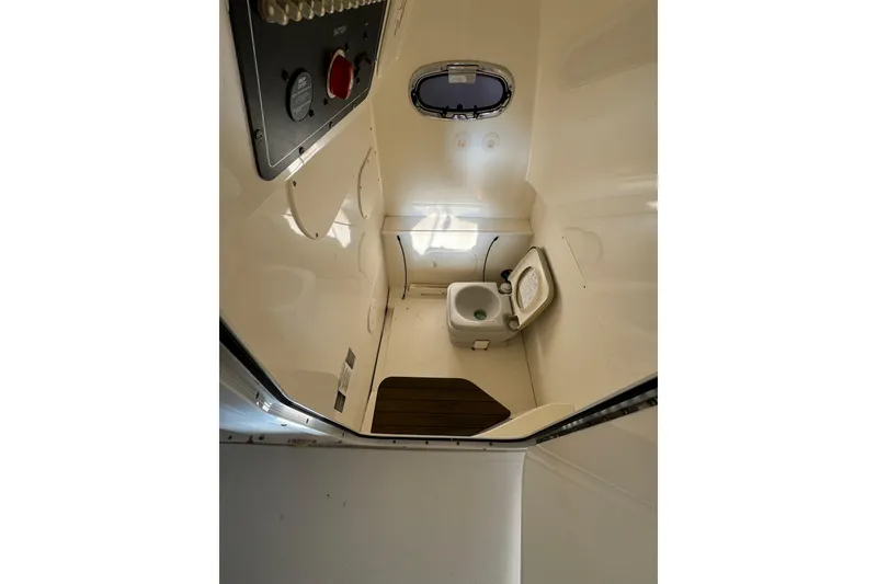 Slide: The Image of 2014 Boston Whaler 270 Dauntless boat interior with compact marine toilet. - 14