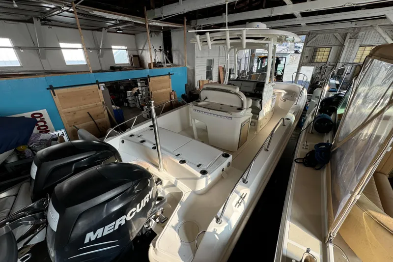 Slide: The Image of 2014 Boston Whaler 270 Dauntless boat in storage with dual Mercury engines. - 2