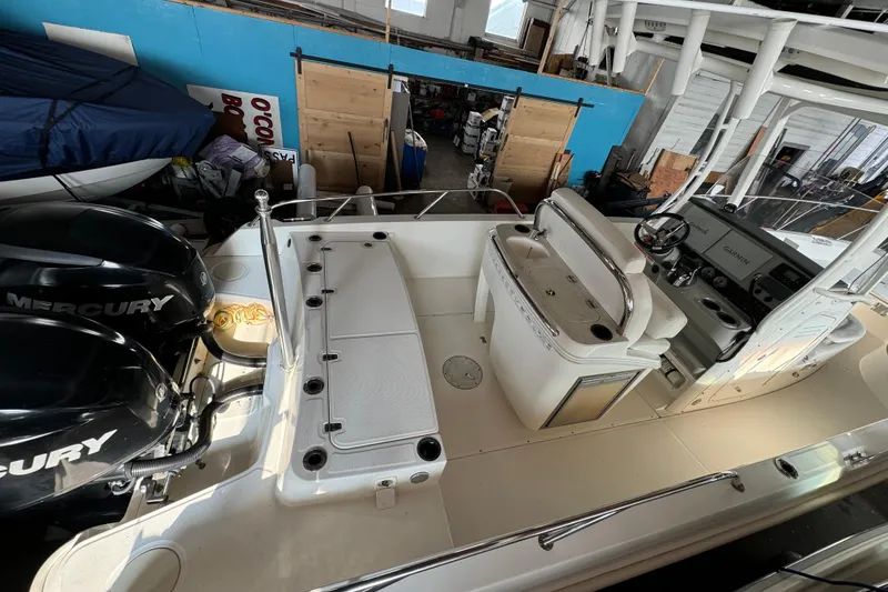 Slide: The Image of 2014 Boston Whaler 270 Dauntless boat interior with Mercury engines in a storage facility. - 6