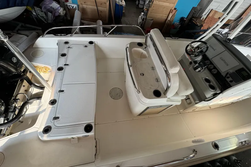 Slide: The Image of 2014 Boston Whaler 270 Dauntless boat interior with seating and Garmin navigation system. - 7