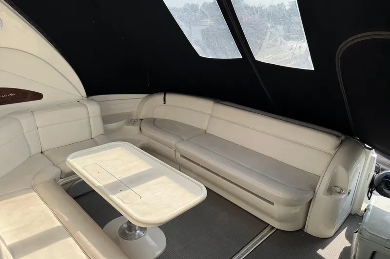 Slide: The Image of Luxurious interior of 2001 Sea Ray 510 Sundancer yacht with white seating and table. - 10