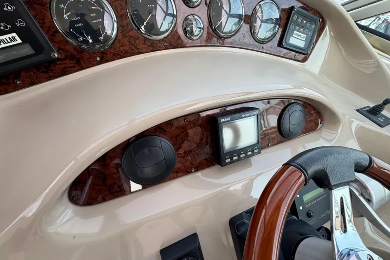 Slide: The Image of Dashboard of 2001 Sea Ray 510 Sundancer with gauges and steering wheel. - 14