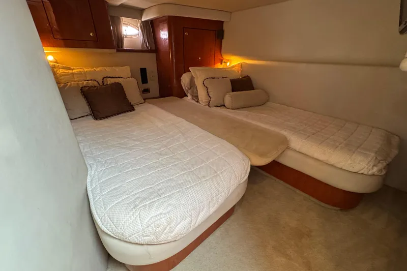 Slide: The Image of Luxurious cabin interior of 2001 Sea Ray 510 Sundancer with twin beds and elegant decor. - 25