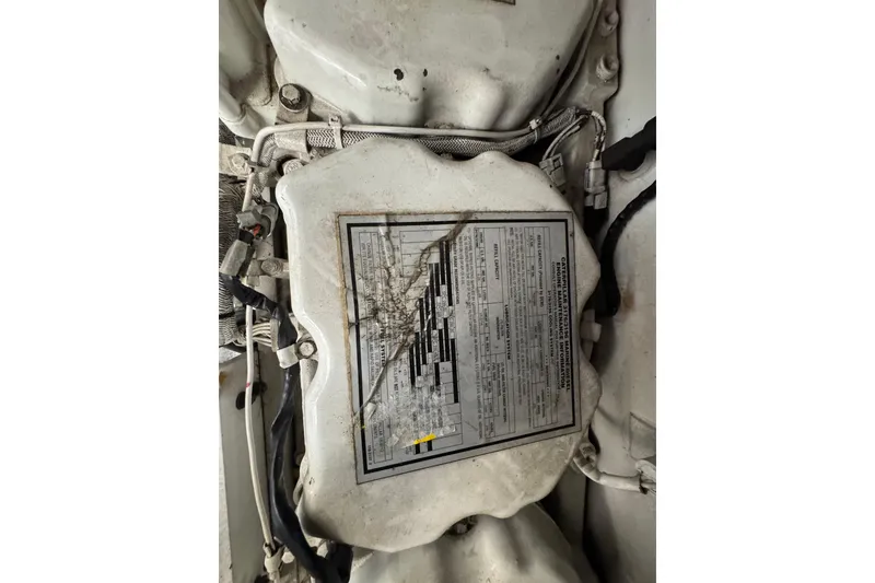 Slide: The Image of Engine compartment of 2001 Sea Ray 510 Sundancer with technical specifications label. - 28