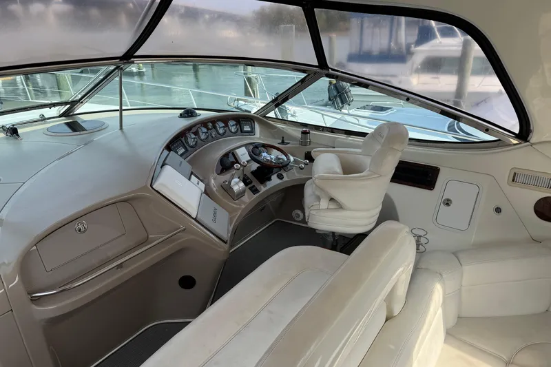 Slide: The Image of 2001 Sea Ray 510 Sundancer helm with leather seating and modern controls. - 7