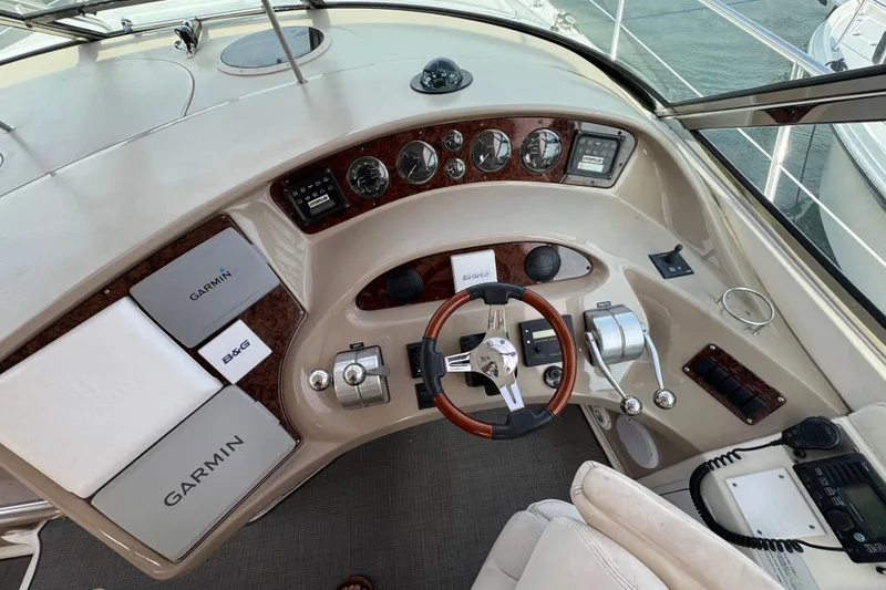 Slide: The Image of 2001 Sea Ray 510 Sundancer helm with Garmin navigation and classic wood accents. - 8