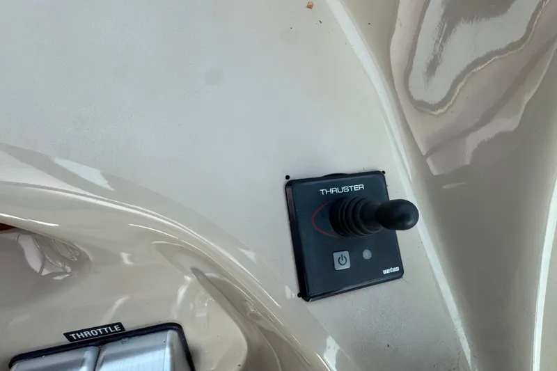 Slide: The Image of Control panel of a 2001 Sea Ray 510 Sundancer with thruster joystick and throttle. - 9