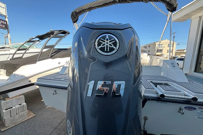 Slide: The Image of 2026 Starcraft SVX 191 OB boat with Yamaha 150 outboard motor, docked outdoors. - 16