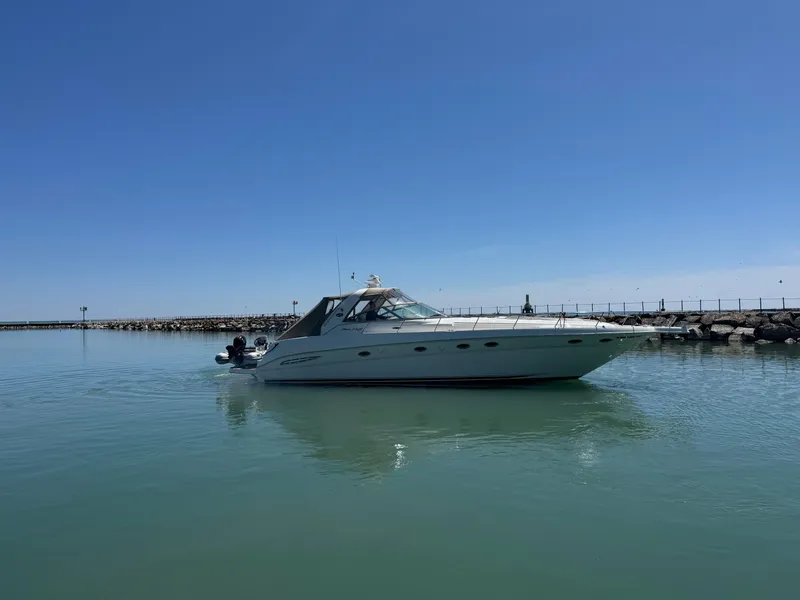 The Image of 2000 Sea Ray 460 Sundancer yacht cruising on calm waters under clear blue sky. - 0