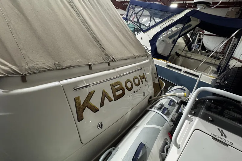 Slide: The Image of Sea Ray 460 Sundancer 2000 yacht named "Kaboom" docked in a marina. - 14