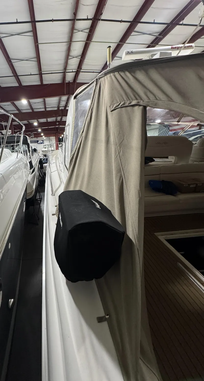 Slide: The Image of 2000 Sea Ray 460 Sundancer yacht in storage, covered and docked indoors. - 15