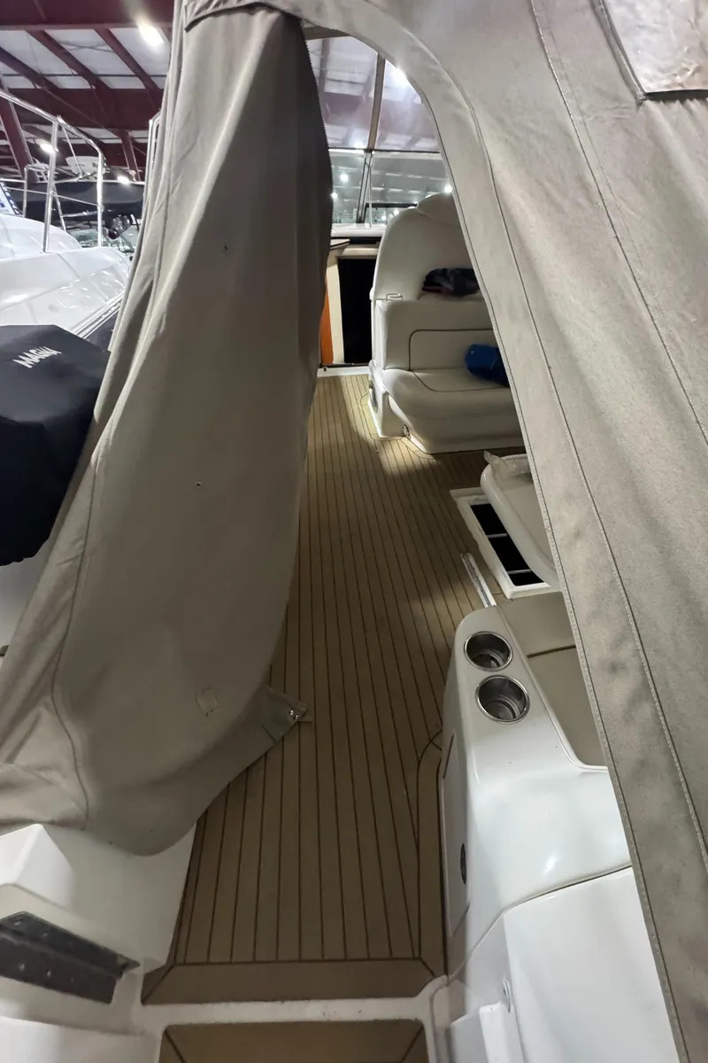 Slide: The Image of 2000 Sea Ray 460 Sundancer interior with covered deck and seating area. - 16