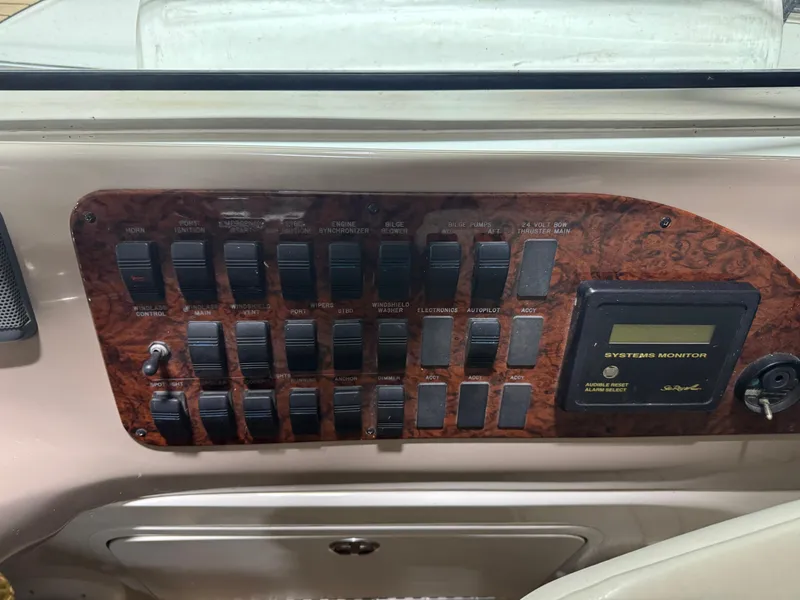 Slide: The Image of Control panel of a 2000 Sea Ray 460 Sundancer boat with switches and system monitor. - 22