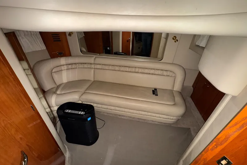Slide: The Image of Interior of 2000 Sea Ray 460 Sundancer with beige seating and wooden accents. - 25
