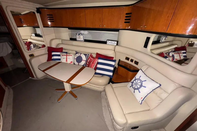 Slide: The Image of Interior of 2000 Sea Ray 460 Sundancer yacht with cozy seating and nautical decor. - 26