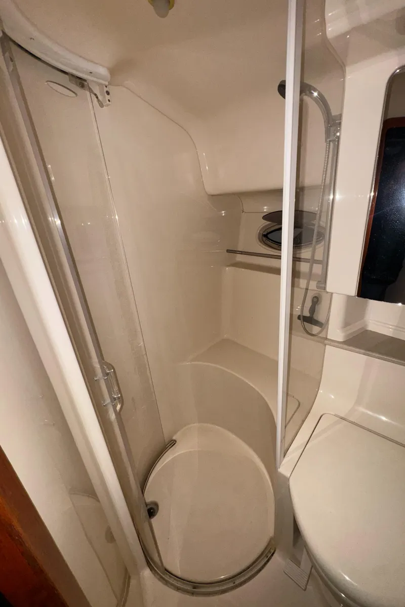 Slide: The Image of Bathroom interior of 2000 Sea Ray 460 Sundancer yacht, featuring shower and toilet. - 28