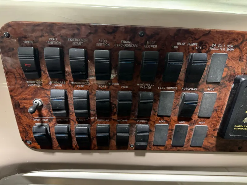 Slide: The Image of Control panel of a 2000 Sea Ray 460 Sundancer boat with various switches. - 33
