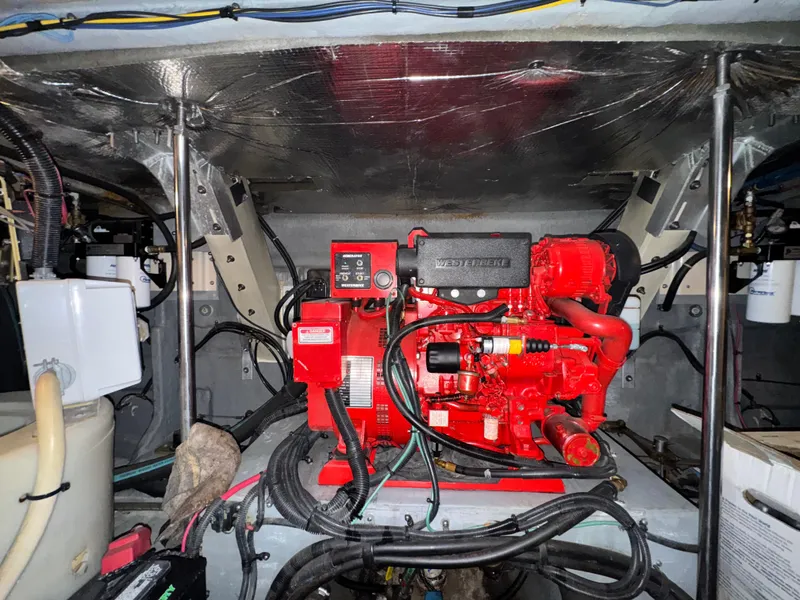 Slide: The Image of Engine room of a 2000 Sea Ray 460 Sundancer with a red generator. - 35