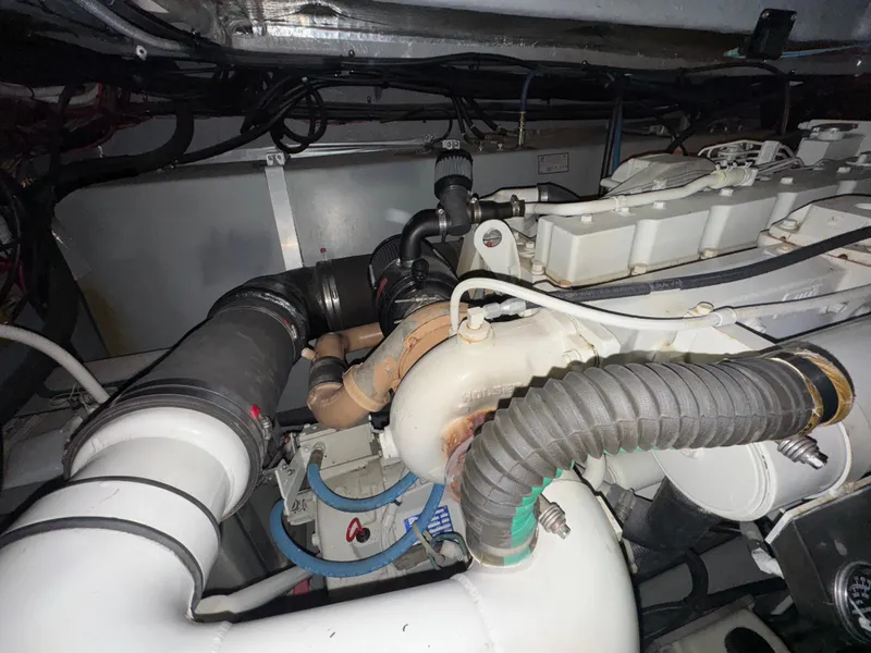 Slide: The Image of Engine compartment of a 2000 Sea Ray 460 Sundancer boat, showcasing mechanical components. - 36