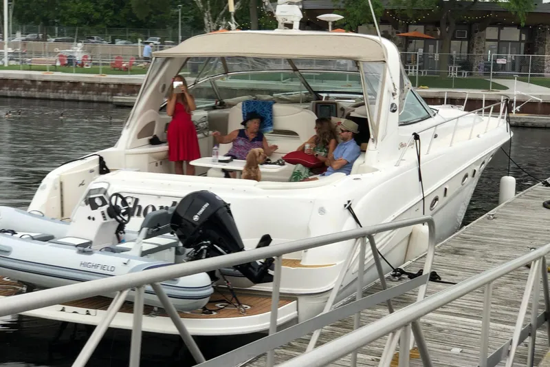 Slide: The Image of 2000 Sea Ray 460 Sundancer yacht docked with people relaxing onboard. - 4