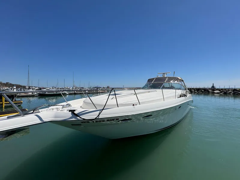 Slide: The Image of 2000 Sea Ray 460 Sundancer yacht docked in a marina under clear blue skies. - 46