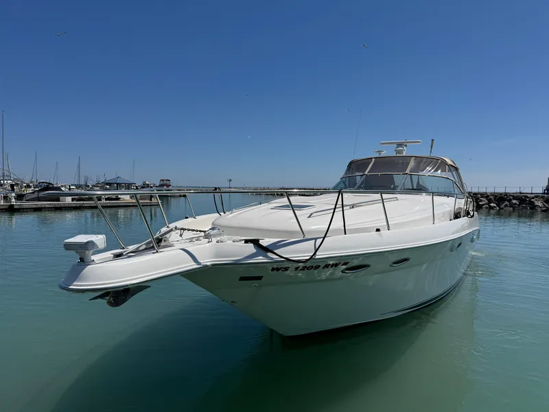 Slide: The Image of 2000 Sea Ray 460 Sundancer yacht docked in a marina under clear blue skies. - 47