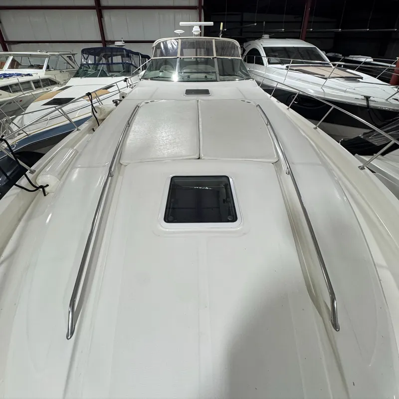Slide: The Image of 2000 Sea Ray 460 Sundancer yacht in storage, showcasing sleek deck design. - 9