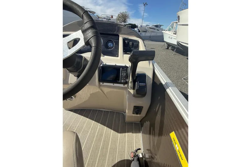 Slide: The Image of 2016 Bennington SX22 boat dashboard with steering wheel and Yamaha controls. - 18