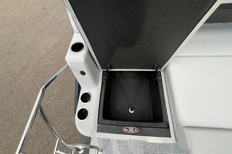Slide: The Image of 2026 Harris Cruiser 230 boat interior with cup holders and storage compartment. - 18