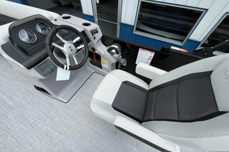 Slide: The Image of 2026 Harris Cruiser 230 boat cockpit with steering wheel and comfortable seating. - 21