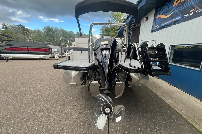 Slide: The Image of 2026 Harris Cruiser 230 pontoon boat with outboard motor, docked at marina. - 27