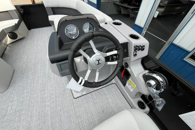 Slide: The Image of 2026 Harris Cruiser 230 boat dashboard with steering wheel and control panel. - 46