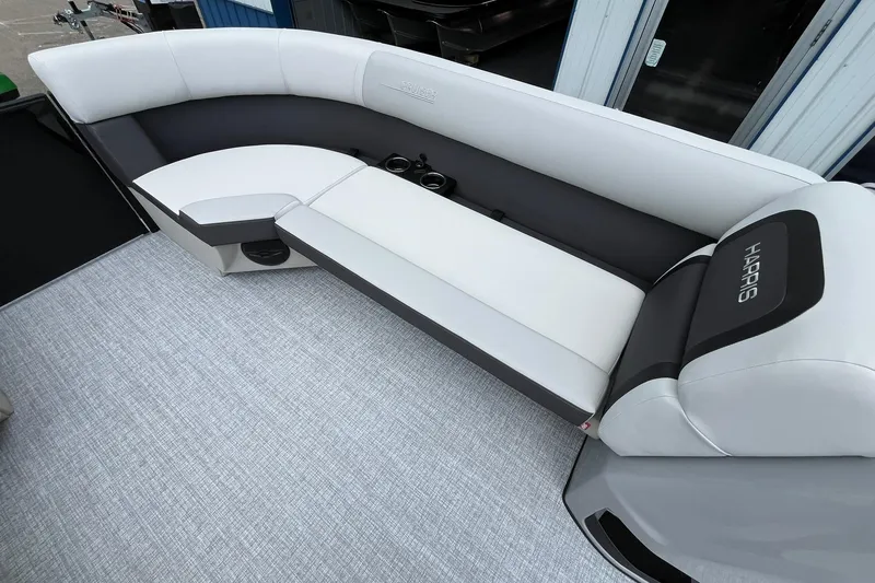 Slide: The Image of 2026 Harris Cruiser 230 boat interior with sleek seating and cup holders. - 48