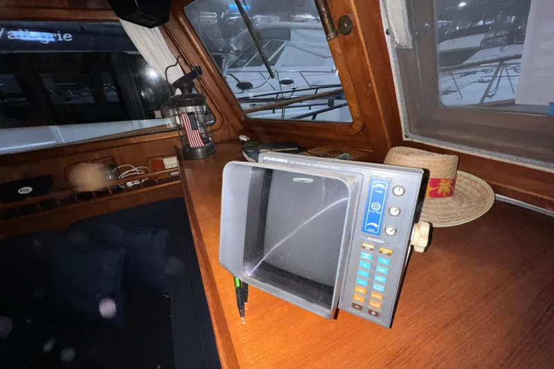 Slide: The Image of 1979 Litton Trawler cockpit with Garmin GPS devices and compass on wooden dashboard. - 10