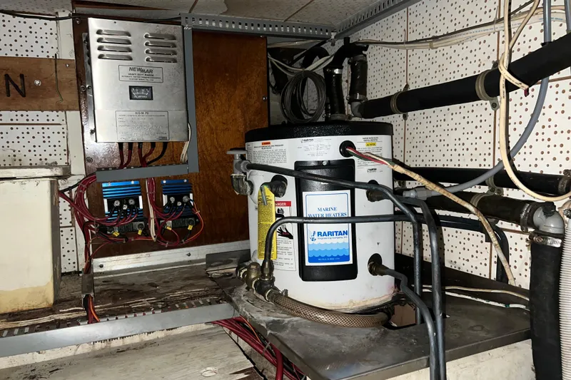 Slide: The Image of Engine compartment of a 1979 Litton Trawler with visible red machinery and hoses. - 19