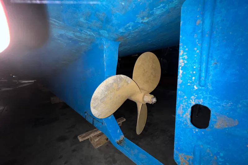 Slide: The Image of 1979 Litton Trawler deck with anchor, ropes, and winch in a marina setting. - 22