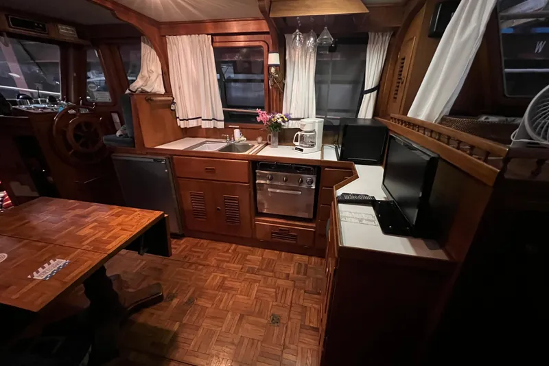 Slide: The Image of 1979 Litton Trawler bathroom with wooden cabinetry, toilet, and sink area. - 4