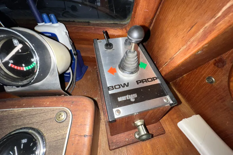 Slide: The Image of 1979 Litton Trawler dashboard with RPM and amp gauges, wooden panel. - 8