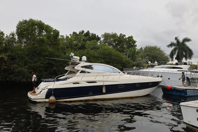 Slide: The Image of 2007 Cranchi Mediterranee 50 HT yacht docked near lush greenery and other boats. - 1