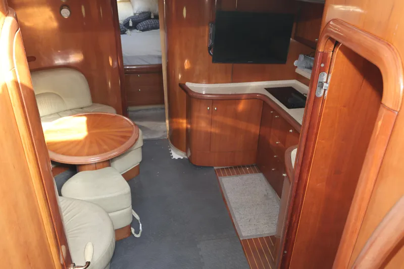 Slide: The Image of 2007 Cranchi Mediterranee 50 HT yacht interior with wood finish, seating, and kitchenette. - 18