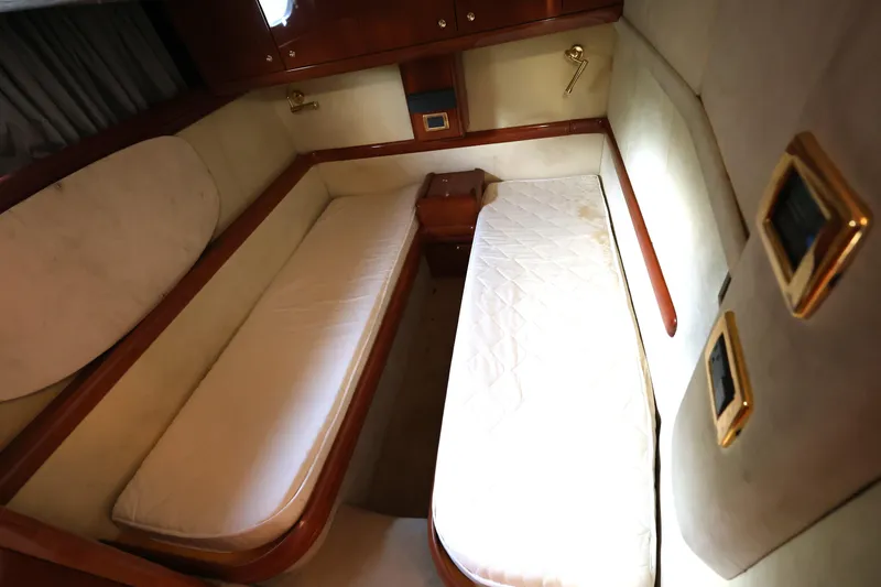 Slide: The Image of 2007 Cranchi Mediterranee 50 HT cabin with twin beds and wooden accents. - 26