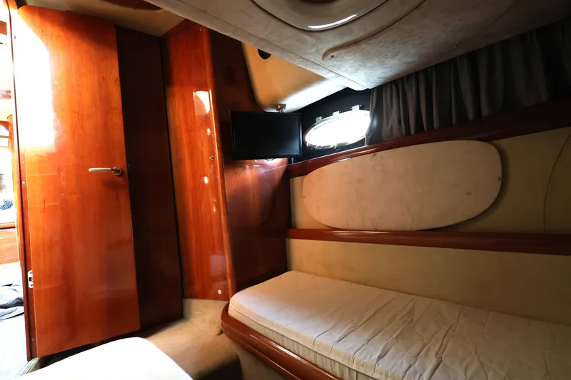 Slide: The Image of 2007 Cranchi Mediterranee 50 HT cabin interior with wooden finish and cozy sleeping area. - 27