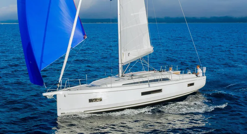 The Image of 2026 Beneteau Oceanis 40.1 sailing yacht with blue and white sails on open water. - 0